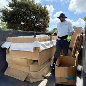 High Caliber Junk Removal worker loading furniture