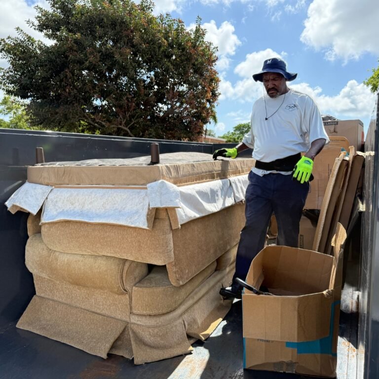 High Caliber Junk Removal team member removing sofa and household items during residential junk cleanout in Broward County Florida