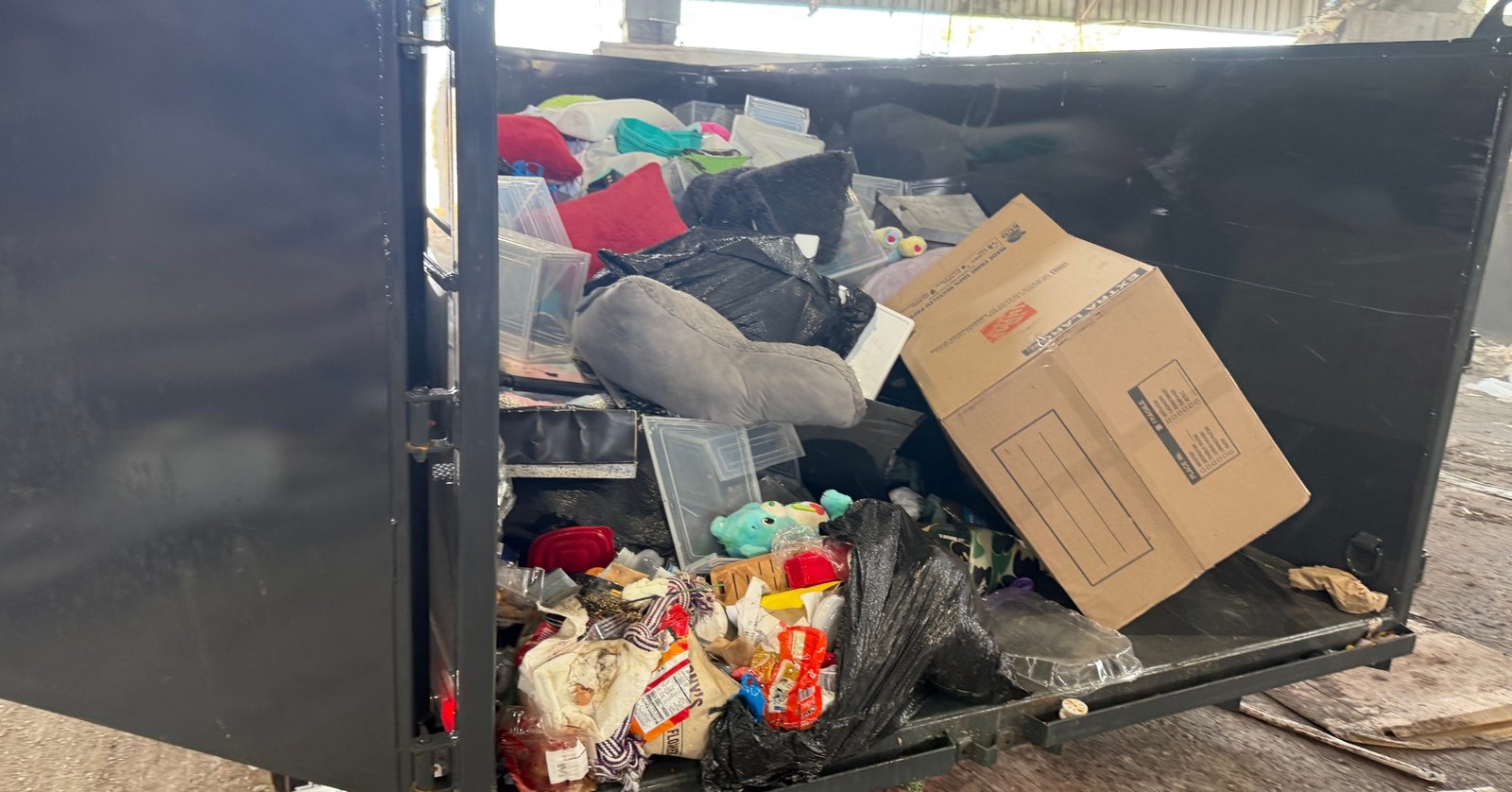 High Caliber Junk Removal dump trailer fully loaded with household junk and debris at disposal facility in Broward County Florida