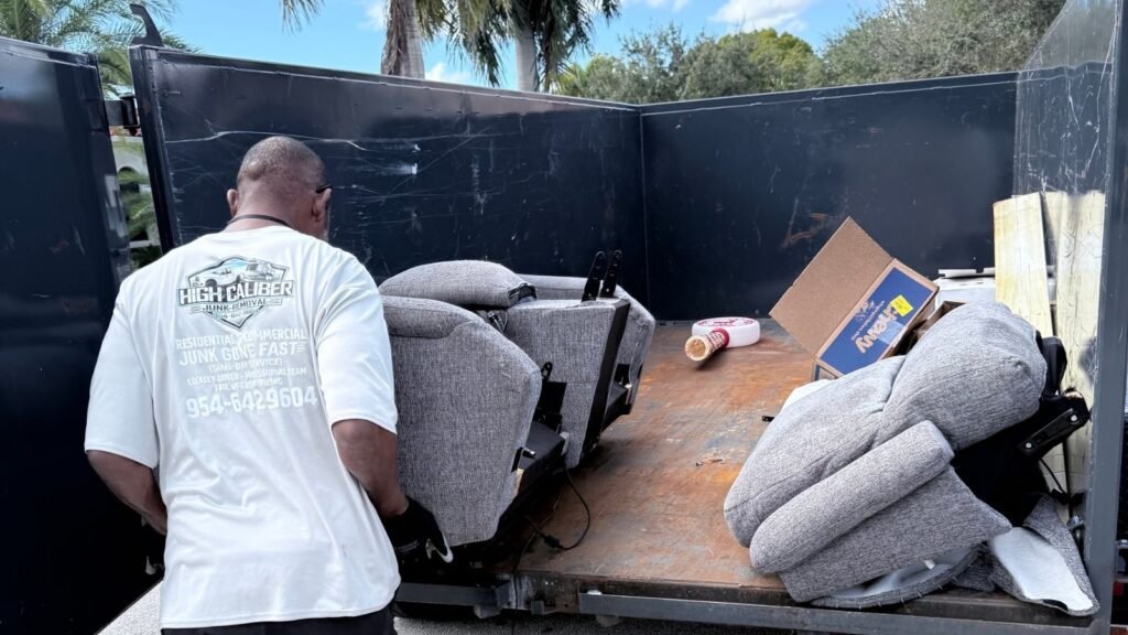 Furniture being loaded into junk removal trailer