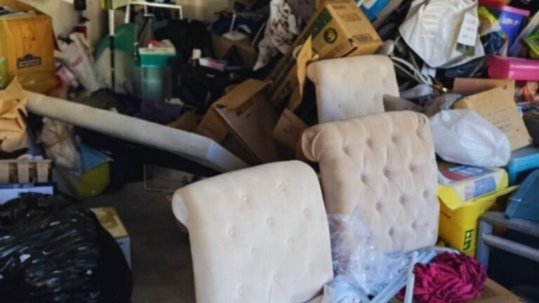 Cluttered garage with furniture and household items before cleanout