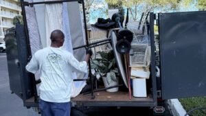 High Caliber Junk Removal crew loading a trailer during a cleanout in Broward County